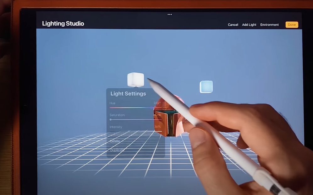 A picture of an iPad with a hand using a pen on Procreate to create a 3D object