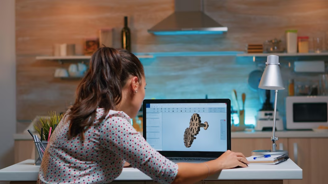 Woman creating a 3D object on a computer