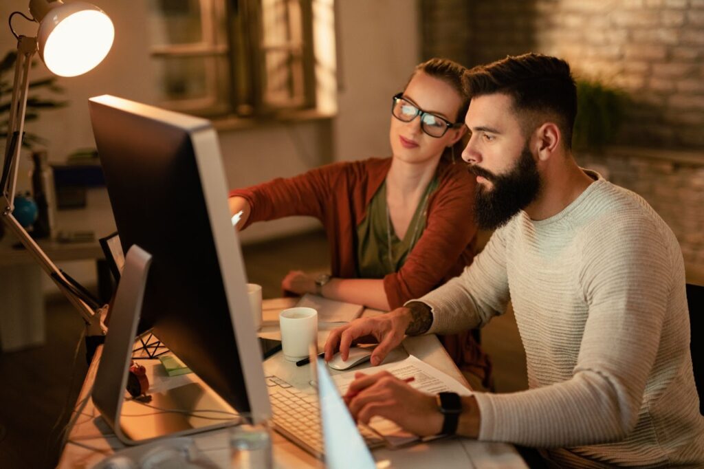 A man and a woman are discussing a project