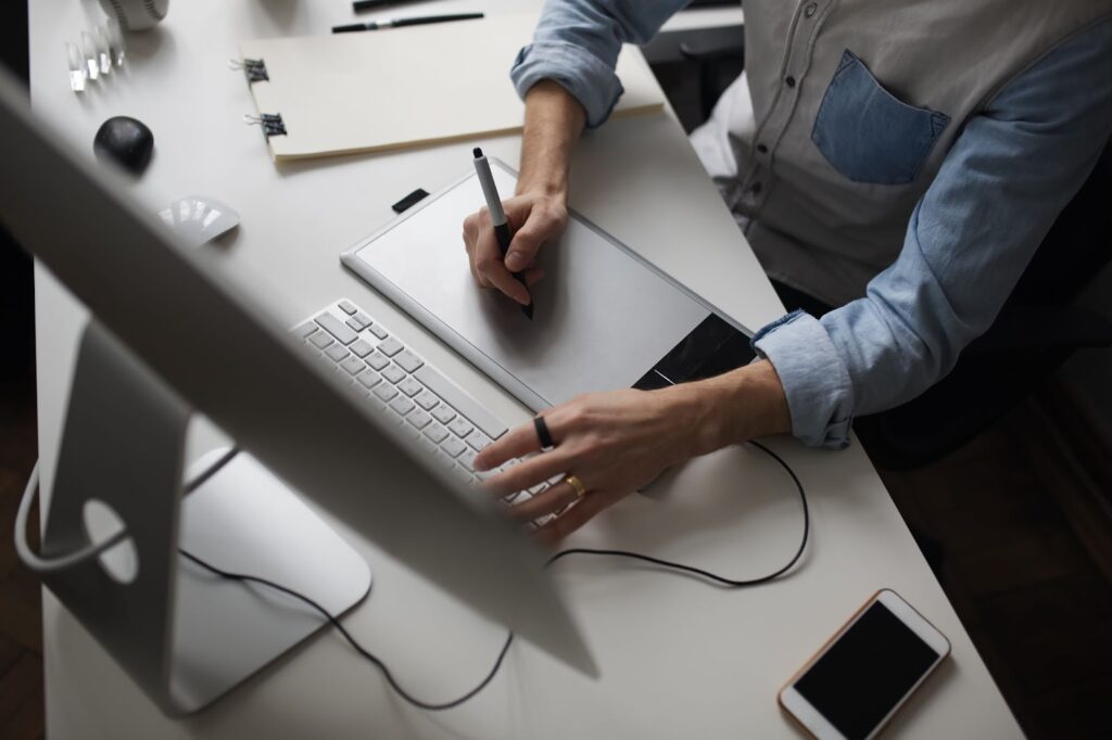 Male designer using graphics tablet while working